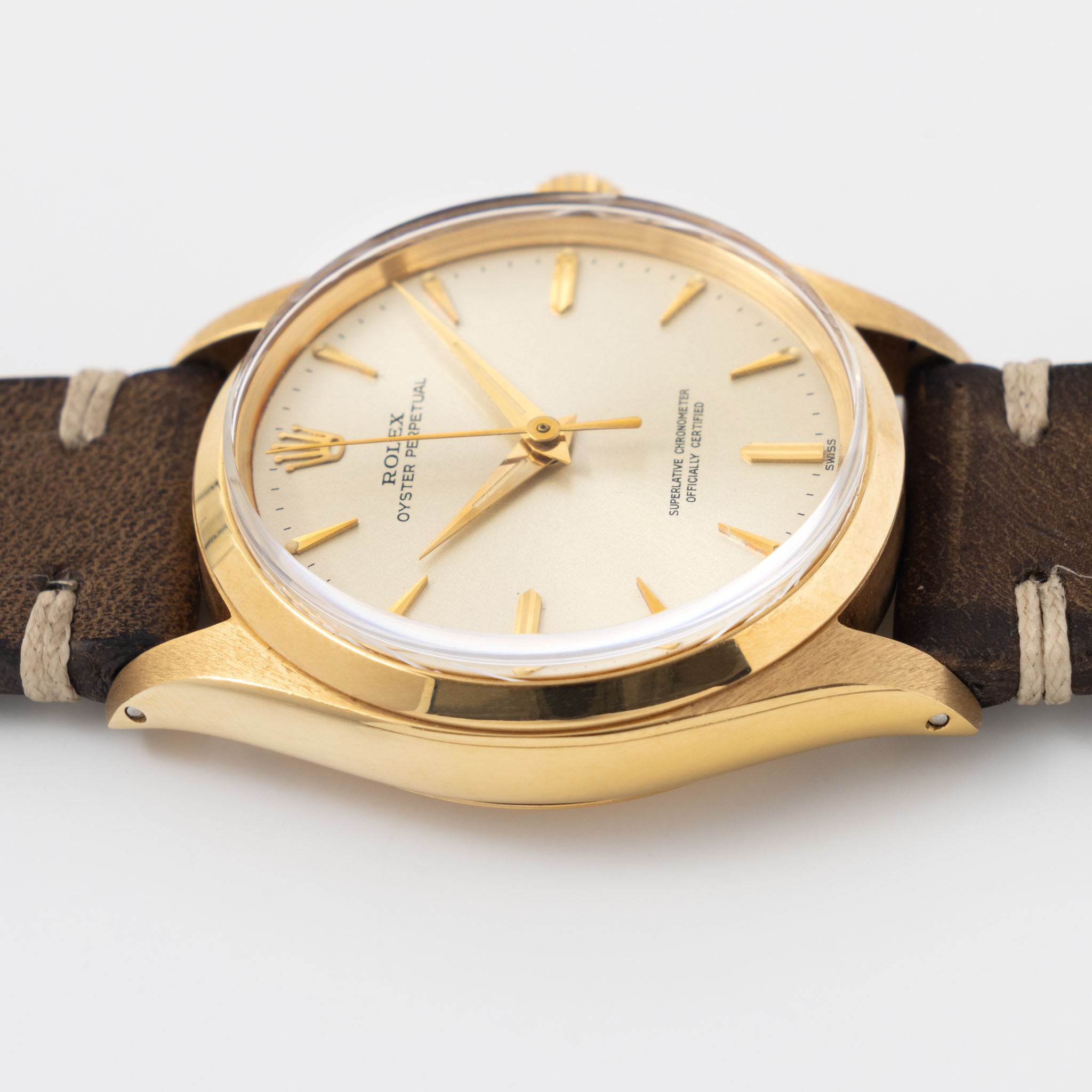 Rolex Oyster Perpetual 1002 Silver Soleil Swiss Only Dial in 18 k yellow gold Coca Cola
